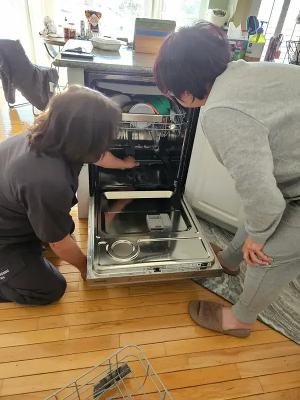 Mid America Service technicians repairing a dishwasher in St. Peters, Missouri