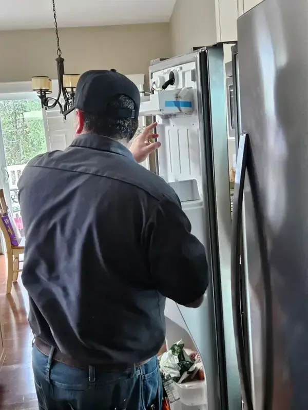 Mid America Service technician repairing a refrigerator in St. Peters, Missouri